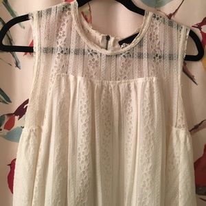 Sleeveless white lace tunic